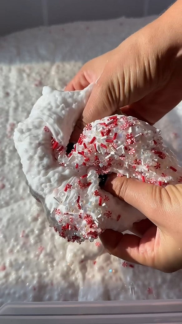 Nichole Jacklyne making peppermint mocha slushee slime with Victory Pellets poly beads, featuring red and white candy cane charms and sparkling glitter for ASMR and holiday sensory crafts