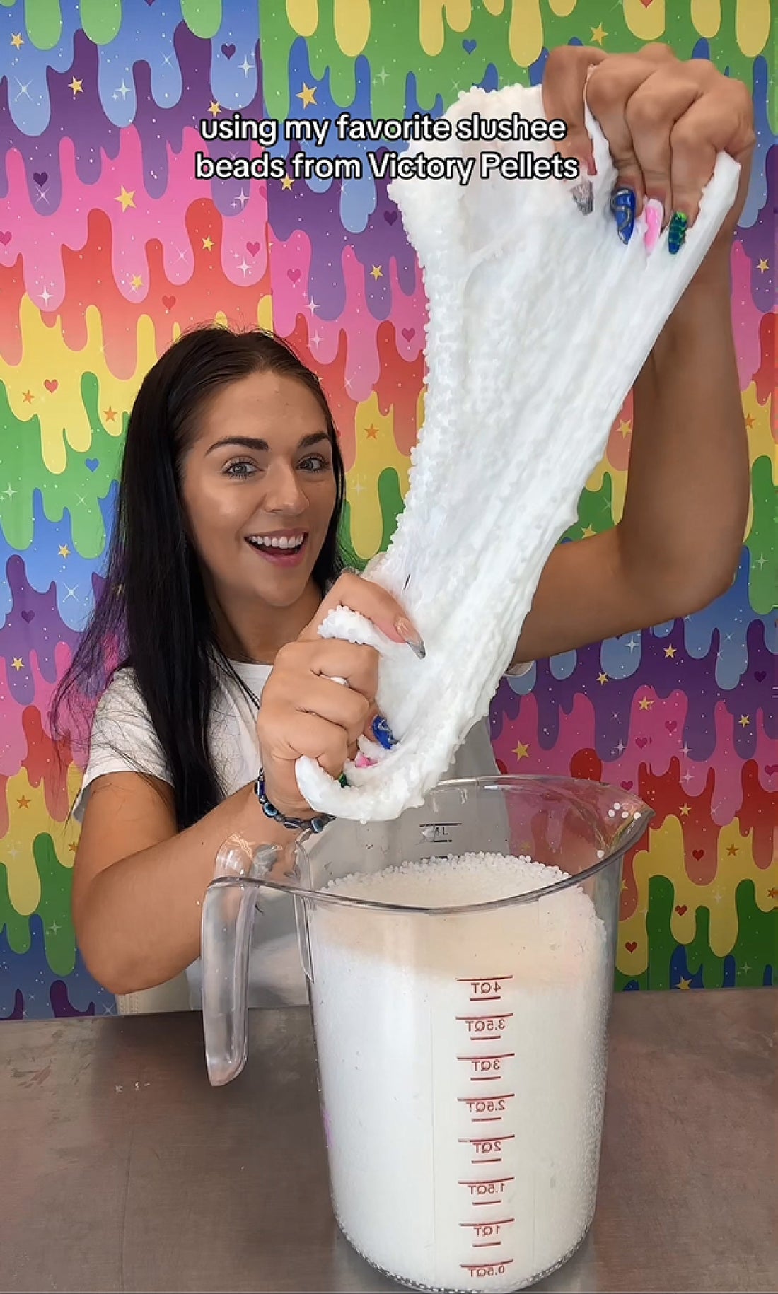 Nichole Jacklyne pouring Elmer’s White Glue and mixing in Victory Pellets to create Crunchy Slushee Slime–shown stretching, popping, and crackling for ASMR sounds