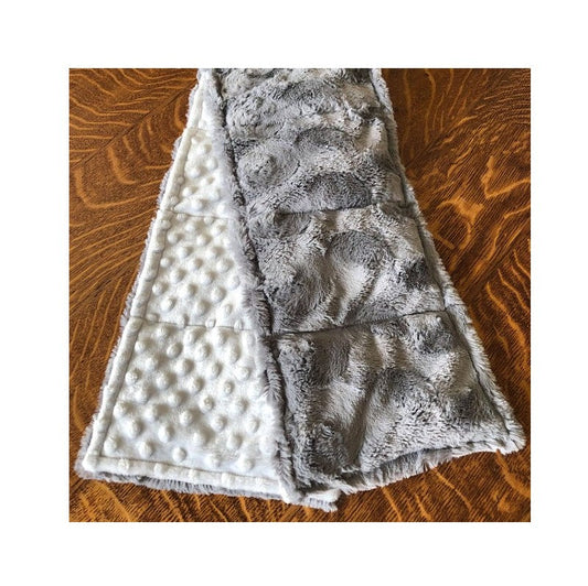 Weighted neck wrap resting on a cozy surface with steam rising gently, filled with Victory Pellets–durable, moisture-resistant, and designed for comfort and longevity.
