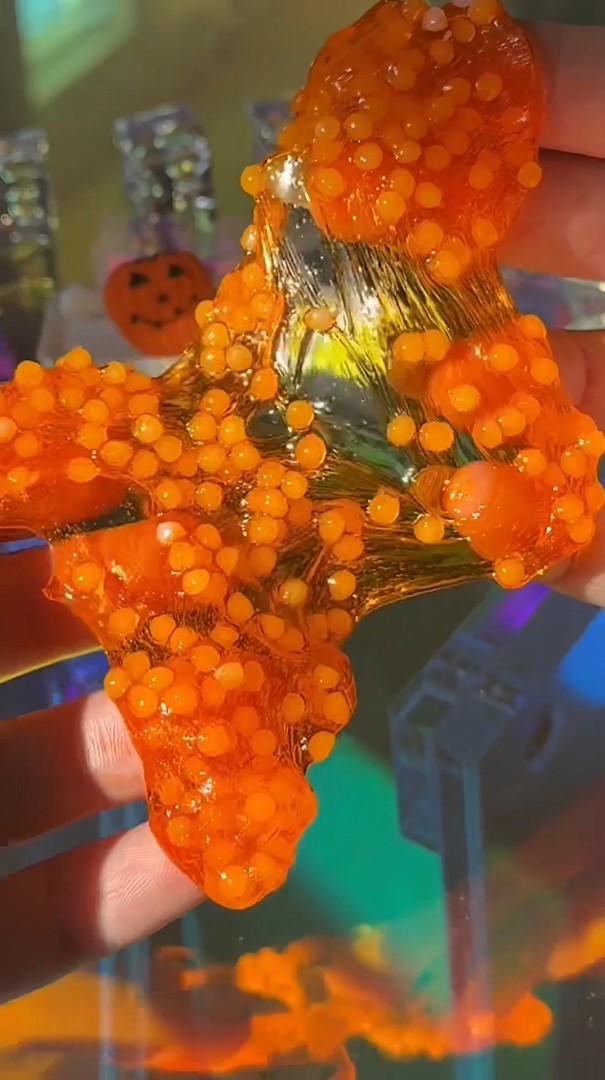 Nichole Jacklyne making Mini Halloween Slushee Slime with Victory Pellets poly beads, pumpkin orange pigment, and cute skeleton and bone charms for ASMR play